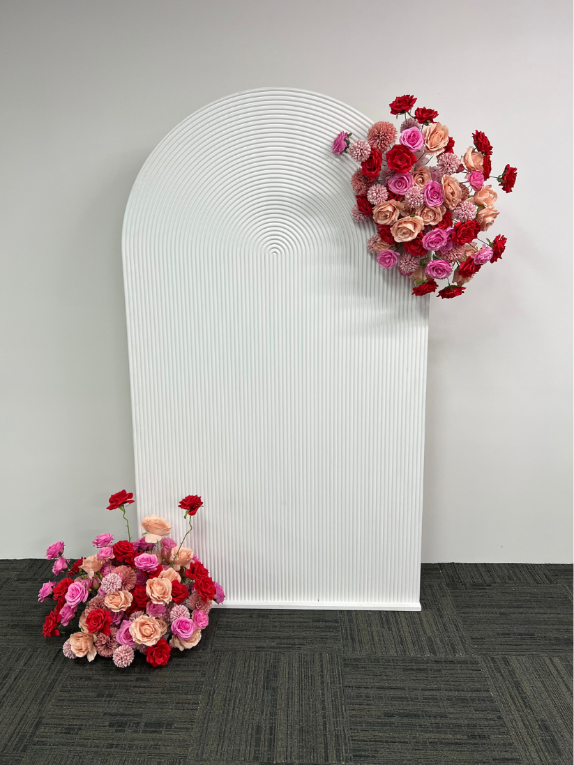 White Ripple Arch backdrop with Flower arrangement Hire